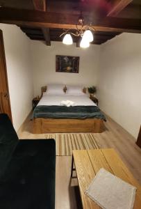 a bedroom with a large bed and a table at SóVárLak in Sărăţeni