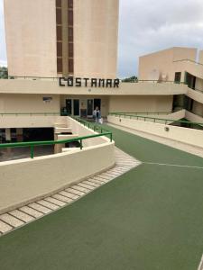 a building with a tennis court in front of it at Apartamentos Costamar in Arona