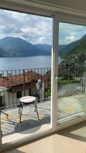 a view of a balcony with a view of the water at Casa Mille Luci in Argegno
