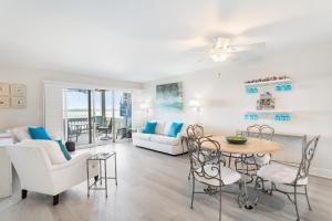a living room with a couch and a table and chairs at 1315 Pelican Watch - Seabrook Island - Beachfront 5 Star Condo - Fido Friendly in Seabrook Island