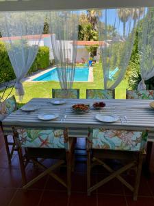 a blue table with chairs and a meal on it at Casa das Cores in Sesimbra