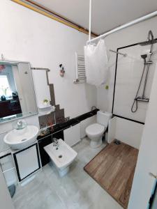 a bathroom with a white toilet and a sink at WYPOSAŻONY apartament przy strumyku w Górach Sowich, Netflix i Smart TV, Odpocznij w naturze! in Walim