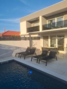 a house with a swimming pool next to a building at Villa Maris Nin in Nin