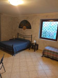 a bedroom with a bed and a stained glass window at b&b Casa Regina in Stroncone
