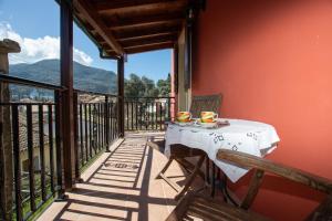 a table on a balcony with a view of the mountains at Aggelina's House by GuestCorfu in Kynopiástai