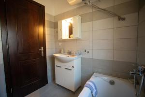 a bathroom with a sink and a toilet and a tub at Aggelina's House by GuestCorfu in Kynopiástai