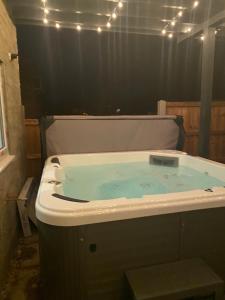 a bath tub filled with blue water with lights at •11 The Nook in Wivenhoe