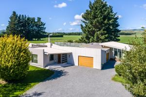 a large white house with a driveway at Paradise on Campbell in Martinborough