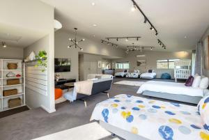 a bedroom with two beds and a living room at Paradise on Campbell in Martinborough