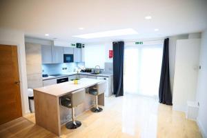 a kitchen with a island in the middle of a room at A Brand New Massive 4 Bed Villa in Rainham Essex London in Rainham