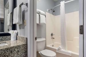 a bathroom with a toilet and a sink and a shower at Best Western Navarre Waterfront in Navarre