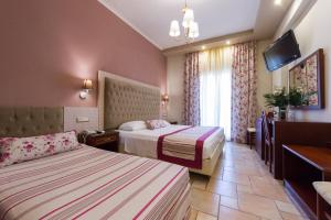 Postel nebo postele na pokoji v ubytování Olympic Hotel