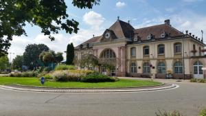 a large building with a clock on the top of it at Studios near Basel Airport in Saint-Louis