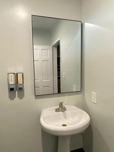 a bathroom with a white sink and a mirror at Harbor Inn in Harbor City