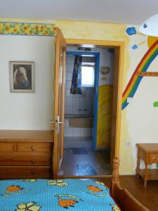 a room with a bathroom with a rainbow on the wall at Sonnenhof in Ziemetshausen bei Legoland Günzburg in Ziemetshausen