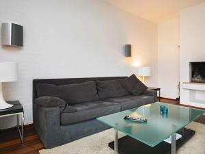 a living room with a couch and a table at Apartment Skagen XIX in Skagen