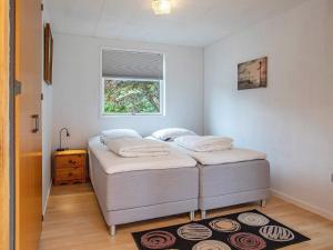 two twin beds in a room with a window at 5 person holiday home in Væggerløse-By Traum in Marielyst