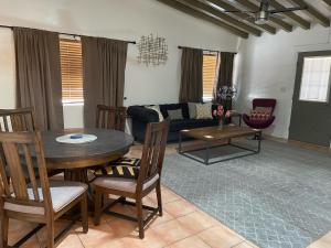 a living room with a table and a couch at Float Palm Springs - Adults Only in Palm Springs
