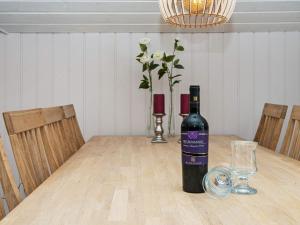 a bottle of wine sitting on top of a table at 6 person holiday home in Hemmet in Falen
