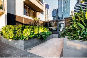 a courtyard with plants in a building at Rome Sky Villa in Melbourne