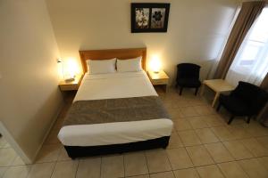 Postel nebo postele na pokoji v ubytování Tropic Coast Motel