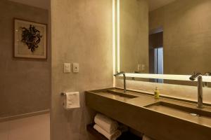 a bathroom with two sinks and a large mirror at Casa Quiote Hotel Boutique City Center based - Adults Only in Oaxaca City +17 photos