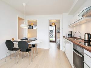 a kitchen with a table and chairs in a room at Apartment Bogense LXI in Bogense