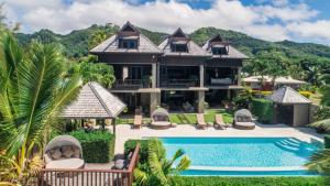 an image of a house with a swimming pool at Te Vakaroa Villas in Rarotonga