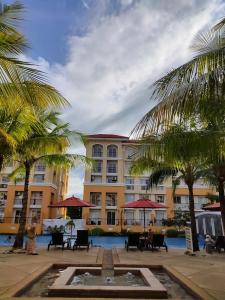 a hotel with a fountain in front of a building at San Remo Oasis 2BR Gusbek Condo Unit Rental in Basak