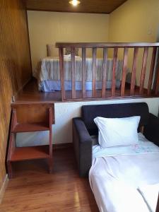 a small room with a bunk bed and a crib at Casa do Lago in Gramado