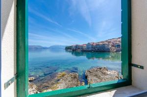 a view of the water from a window at Apartment Paradise in Postira