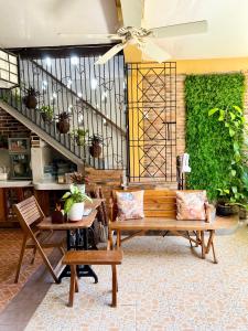 a living room with a bench and a staircase at Balai Tinay Guesthouse in Legazpi