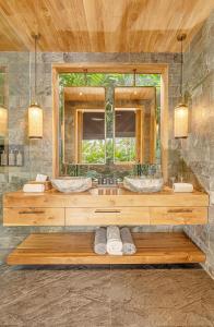 a bathroom with two sinks and a mirror at Desa Hay Canggu in Canggu