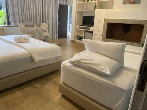 a bedroom with two beds and a fireplace at Milord Hotel in Encarnación