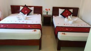 Postel nebo postele na pokoji v ubytování Mango Garden Hoi An Homestay