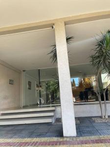 a building with a lobby with palm trees in it at HERMOSO DEPARTAMENTO AMUEBLADO EN EL CENTRO DE LP in La Plata