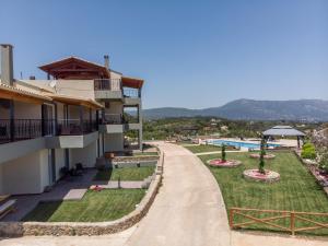 a road leading to a resort with a swimming pool at Heaven Hill Villas ground floor in Gouvia