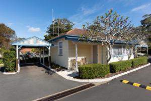 a house with a gazebo next to a street at Forster Holiday Village in Forster