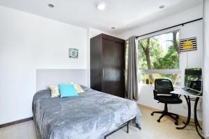 a bedroom with a bed and a desk at International House Co-Living in Medellín