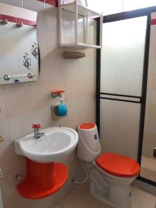 a small bathroom with a sink and a toilet at Hotel Los Corales Tulua in Tuluá +22 photos