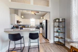 a kitchen with a counter and two stools at Coastal Comfort in Galveston