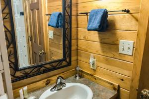 Cove Cabin Retreat في Shelter Cove: حمام مع حوض ومرآة