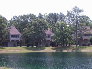 a row of houses next to a lake at Waterwood Townhouses, a VRI resort in New Bern