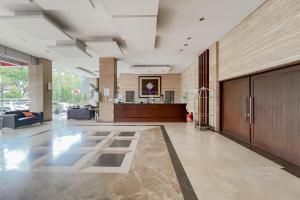 a large room with a lobby with a couch and a table at Urbanview Hotel Newton Riau Bandung by RedDoorz in Bandung