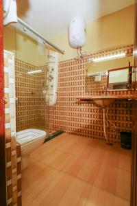 a bathroom with a toilet and a sink at Hotel Sagarmatha in Bīr