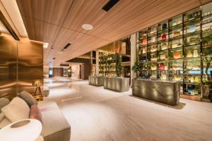 a lobby of a hotel with a bar with wine bottles at Ashley Tanah Abang in Jakarta
