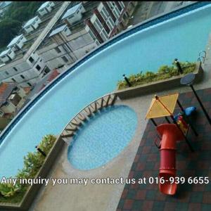 an image of a swimming pool with a sign next to it at Homestay Apartment KB @ D'perdana Condo in Kota Bharu