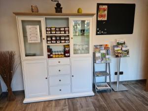 a large white cabinet with medicines in it at Gästehaus Portugall in Ellenz-Poltersdorf