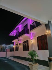 a building with purple lights on it at night at VILLA WANIE INN in Setiu