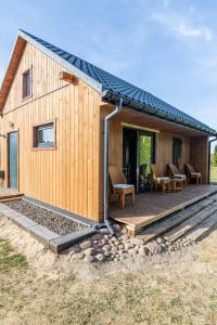 a house with a solar roof on a wooden deck at Apartamenty Leśne Zacisze in Lublin